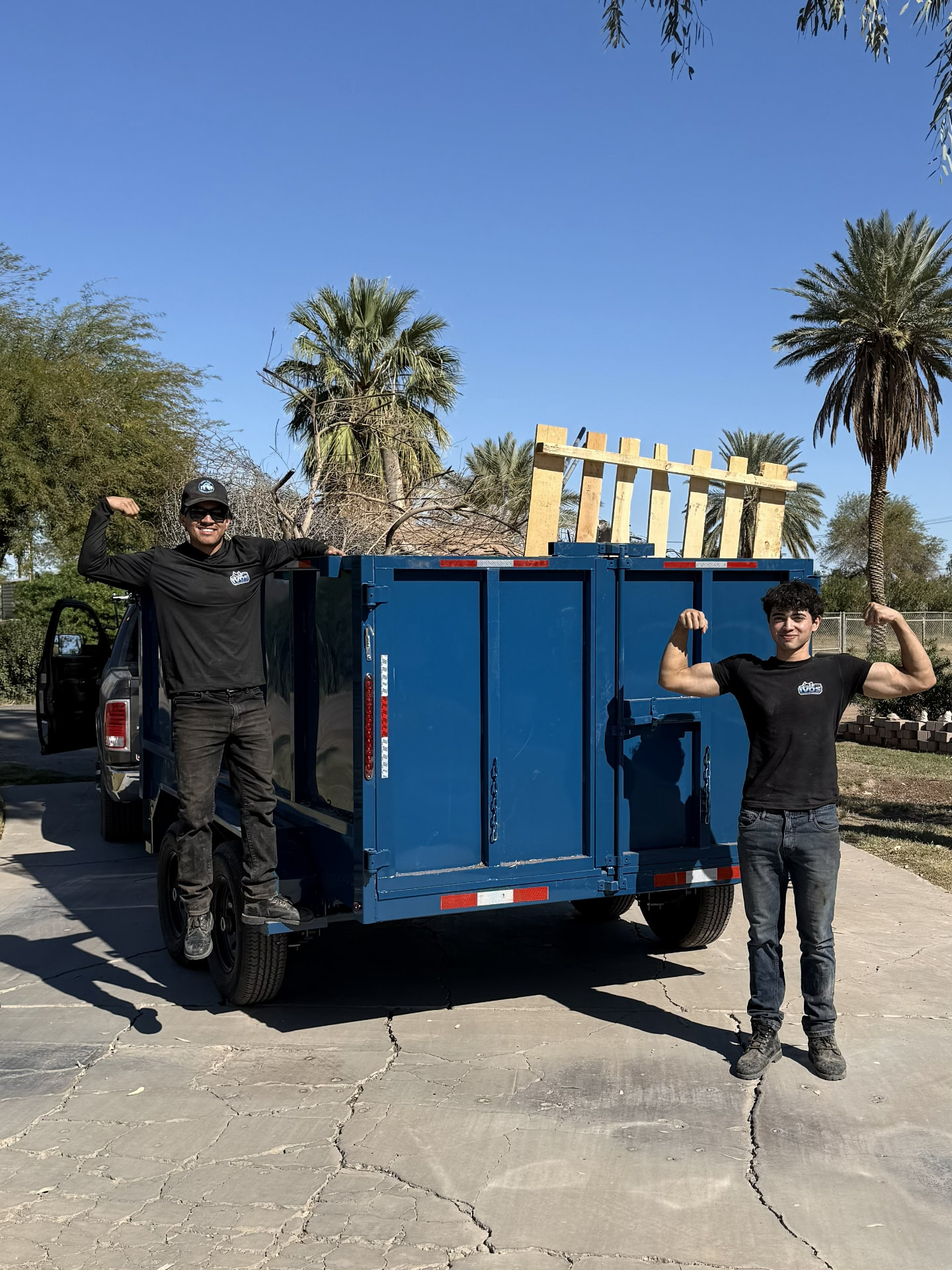 IVOS founders standing with their blue trailer in the Imperial Valley
